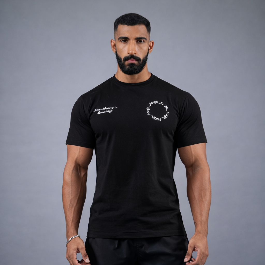 Man wearing a black t-shirt with white text and graphics on a gray background